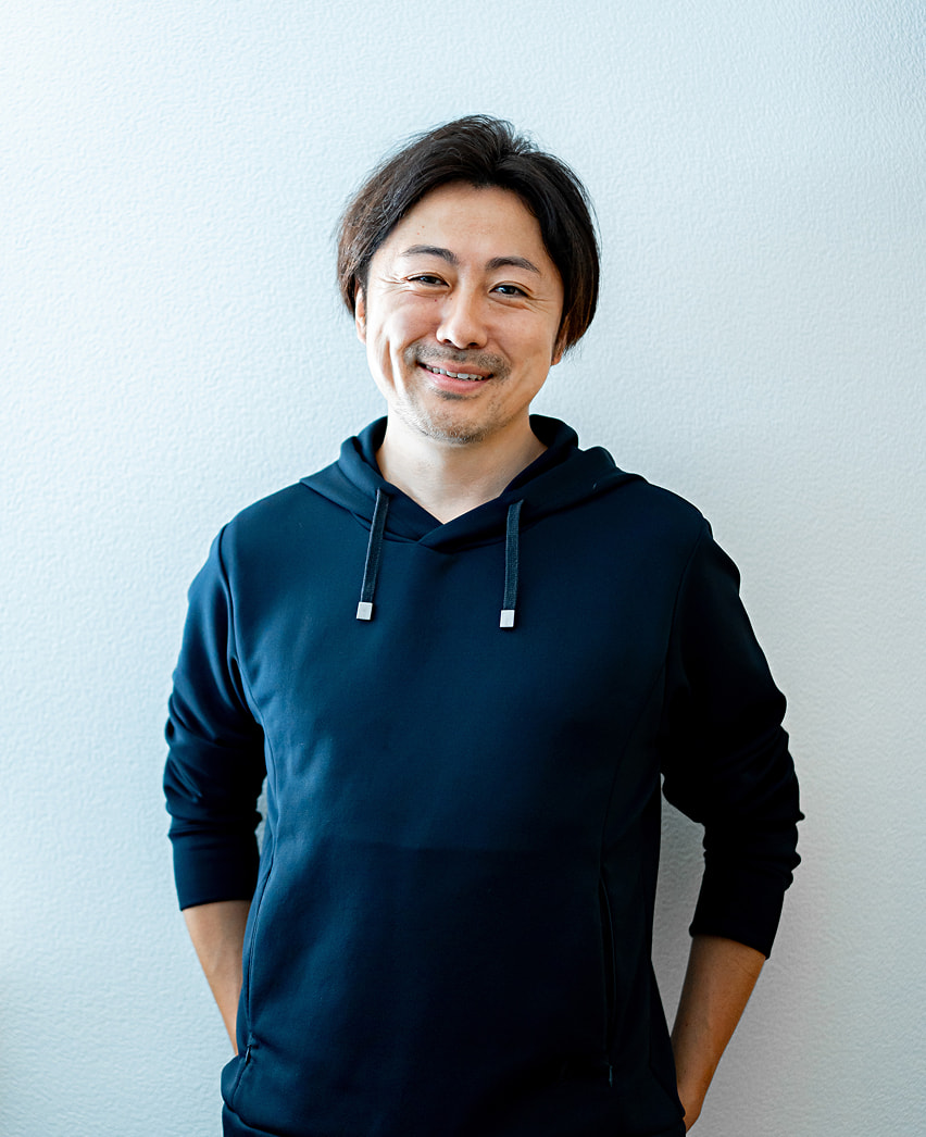 笑顔で立つ男性のポートレート写真
